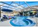 Inviting screened-in pool area with lounge chairs, umbrellas, and outdoor seating at 15373 Murcott Harvest Loop, Winter Garden, FL 34787