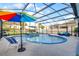 Beautiful screened-in pool area with lounge chairs, umbrellas, and a spacious patio at 15373 Murcott Harvest Loop, Winter Garden, FL 34787