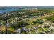 Wide aerial view of a neighborhood with a mix of houses, green spaces, and a scenic lake at 16344 Magnolia Bluff Dr, Montverde, FL 34756