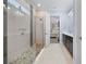 Luxurious bathroom featuring a walk-in shower with pebble flooring and a glass enclosure at 1905 Estuary Ln, Kissimmee, FL 34747