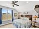 Comfortable bedroom with a queen-sized bed, blue drapes, and ample natural light at 1905 Estuary Ln, Kissimmee, FL 34747
