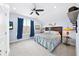 Bright bedroom with large window, ocean-themed bedding, and modern ceiling fan for optimal comfort and relaxation at 1905 Estuary Ln, Kissimmee, FL 34747