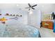 Well-lit bedroom features decorative shelving, light blue walls, and comfortable carpet at 1905 Estuary Ln, Kissimmee, FL 34747