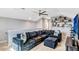 Inviting bonus room featuring a sectional sofa, decor shelving, and comfortable setting at 1905 Estuary Ln, Kissimmee, FL 34747