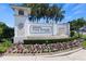 The K. Hovnanian's Four Seasons at Orlando community sign welcomes with flowers and lush palms at 1905 Estuary Ln, Kissimmee, FL 34747