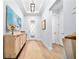 Bright entryway with tray ceiling, decorative console table, and view of the home's interior at 1905 Estuary Ln, Kissimmee, FL 34747