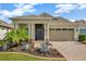 Charming single-story home with a well-manicured lawn and attractive desert-style landscaping at 1905 Estuary Ln, Kissimmee, FL 34747