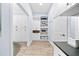 Organized laundry room boasts built-in shelving and plenty of storage space in a modern, stylish design at 1905 Estuary Ln, Kissimmee, FL 34747