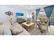 Cozy living room with comfortable seating, stylish decor, and sliding glass doors to the outdoor pool area at 1905 Estuary Ln, Kissimmee, FL 34747