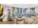 Bright living room with large windows, elegant furniture, and an open view of the dining area at 1905 Estuary Ln, Kissimmee, FL 34747