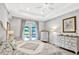 Elegant bedroom with neutral tones, a decorative ceiling fan, and a view of the outdoor pool area at 1905 Estuary Ln, Kissimmee, FL 34747