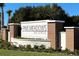 Elegant community entrance sign for Pine Meadows Reserve, surrounded by lush landscaping at 2051 Town Pasture Dr, Eustis, FL 32726