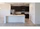 Open kitchen with a center island, stainless steel appliances, and dark cabinets at 2051 Town Pasture Dr, Eustis, FL 32726