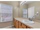 Bright bathroom featuring a long vanity with sink and a window view at 2328 Caravelle Cir, Kissimmee, FL 34746