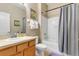 Well-lit bathroom with a vanity, toilet, and shower/tub with gray curtain at 2328 Caravelle Cir, Kissimmee, FL 34746