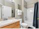 Bright bathroom featuring a shower-tub combo with a curtain and vanity with sink at 2328 Caravelle Cir, Kissimmee, FL 34746