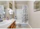 Cozy bathroom featuring a vanity, toilet, and tub/shower with a patterned curtain at 2328 Caravelle Cir, Kissimmee, FL 34746