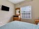 Cozy bedroom featuring a large window and a wooden dresser at 2328 Caravelle Cir, Kissimmee, FL 34746