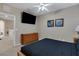 Bedroom with mounted TV, dresser, and view of the upstairs hall at 2328 Caravelle Cir, Kissimmee, FL 34746