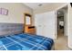 Bedroom featuring a comfortable bed, dresser with mirror, and closet with white double doors at 2328 Caravelle Cir, Kissimmee, FL 34746