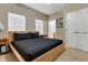 Bright bedroom with a black bedspread, two windows, and a double door closet at 2328 Caravelle Cir, Kissimmee, FL 34746