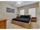 Bedroom with a platform bed, bedside tables, and two windows with blinds at 2328 Caravelle Cir, Kissimmee, FL 34746