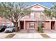 Charming two-story townhome with a brick driveway and landscaped yard, creating a welcoming curb appeal at 2328 Caravelle Cir, Kissimmee, FL 34746