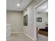 Upstairs hallway showcasing neutral walls and decor with a view into a bedroom at 2328 Caravelle Cir, Kissimmee, FL 34746