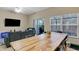 Spacious living room with a large window, a sliding glass door, a ceiling fan, and a dining table at 2328 Caravelle Cir, Kissimmee, FL 34746
