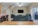Bright living room with a staircase, a ceiling fan, and sliding glass doors leading to the patio at 2328 Caravelle Cir, Kissimmee, FL 34746