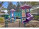 Colorful community playground featuring slides, climbing structures and safe ground cover at 2328 Caravelle Cir, Kissimmee, FL 34746