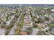 Aerial view showing manicured lawns and beautiful houses lining the streets of this neighborhood at 25239 Cranes Roost Cir, Leesburg, FL 34748