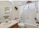 Bright bathroom featuring a vanity with sink, a bathtub and shower with white tile at 25239 Cranes Roost Cir, Leesburg, FL 34748