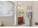 This well lit bathroom features tile floors, a glass enclosed shower and a well-lit vanity with storage at 25239 Cranes Roost Cir, Leesburg, FL 34748