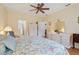 The main bedroom with fan, closet, and dresser offers plenty of space and storage for a peaceful retreat at 25239 Cranes Roost Cir, Leesburg, FL 34748