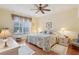Comfortable main bedroom with a ceiling fan and lots of light is the perfect place to unwind and relax at 25239 Cranes Roost Cir, Leesburg, FL 34748