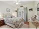 Comfortable bedroom with a decorative bedspread, and a view of the outdoors through French doors at 25239 Cranes Roost Cir, Leesburg, FL 34748