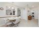 Charming dining area with tiled floor, arched doorways, and easy access to the laundry room at 25239 Cranes Roost Cir, Leesburg, FL 34748
