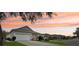 Charming single-story home with a well-manicured lawn and beautiful sunset views at 25239 Cranes Roost Cir, Leesburg, FL 34748