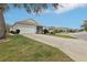 Cozy single-story home with a two-car garage, screened porch and mature landscaping at 25239 Cranes Roost Cir, Leesburg, FL 34748