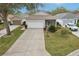 Charming single-Gathering home with a well-manicured lawn, two car garage and inviting front porch at 25239 Cranes Roost Cir, Leesburg, FL 34748