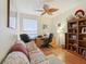 A comfortable home office with a ceiling fan and hard wood floors provides the perfect work-from-home setting at 25239 Cranes Roost Cir, Leesburg, FL 34748