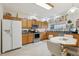 Well-lit kitchen with stainless steel appliances, granite countertops, ample cabinet space, and a breakfast nook at 25239 Cranes Roost Cir, Leesburg, FL 34748