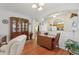 Open living area with hardwood floors, dining furniture, and a built-in hutch at 25239 Cranes Roost Cir, Leesburg, FL 34748