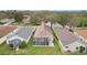 An aerial backyard view of a home featuring an enclosed screened lanai with an outdoor patio set at 25239 Cranes Roost Cir, Leesburg, FL 34748