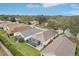 An aerial view of a home featuring an enclosed screened lanai with an outdoor patio at 25239 Cranes Roost Cir, Leesburg, FL 34748