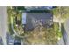 Overhead aerial shot of the home's roof, trees, lawn, and proximity to street at 3001 Bellingham Dr, Orlando, FL 32825