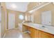 Bright bathroom with a tub, tile floor, octagon window, and a wide mirror at 3001 Bellingham Dr, Orlando, FL 32825