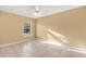 Neutral bedroom featuring a window overlooking the front yard and a ceiling fan at 3001 Bellingham Dr, Orlando, FL 32825