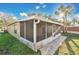Exterior view of the home featuring a screened in lanai and palm trees at 3001 Bellingham Dr, Orlando, FL 32825